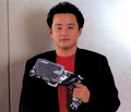 Photo of Kōji Okada holding a GUMP from issue 463